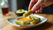© Konstantin - hands dipping pickles in batter