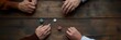 © nopommajun - An overhead shot of players' hands in a poker game, capturing the excitement and tension of competitive strategy, luck, and social interaction in this popular game.