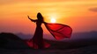 © Ashalina - Silhouette of woman in flowing dress at sunset over desert