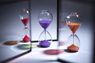 Poster - Colorful Hourglasses Reflecting Time in a Modern Artistic Display