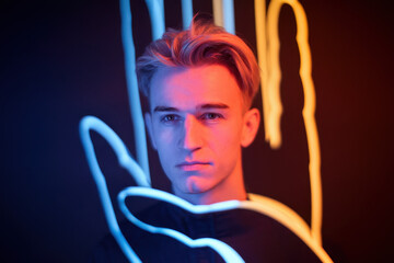 Poster - Intense Young Man with Stylish Hair Surrounded by Colorful Neon Hand Shapes