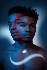 Poster - Introspective Young Man with Abstract Light Reflection in Cool Blue Tones