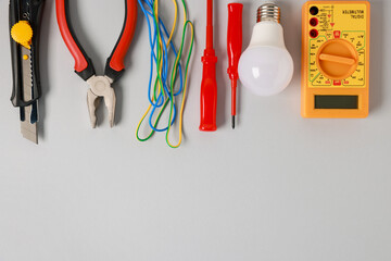 Poster - Different electrical tools on grey background, flat lay. Space for text