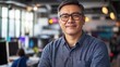 © Daiki - A confident middle-aged Asian male software engineer poses in a modern office. His friendly demeanor highlights professionalism and innovation in a tech environment.