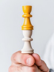 Aufkleber - Strategic Leadership Minimalism Bold Yellow and Neutral Chess Piece Balancing in Human Grip - Empowering Organizational Transformation and Adaptive Business Mindset Visualization