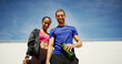 © peopleimages.com - Couple, smile and fitness with portrait, outdoor and low angle in summer with water, support or space for wellness. Man, woman and happy together for workout, training or bottle for exercise with sky