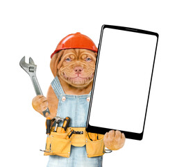 Poster - Smiling Mastiff puppy with adjustable wrench wearing hardhat and overalls with tool belt showing big smartphone with white blank screen in it paw. Isolated on white background. Empty space for text