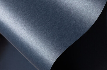 Poster - Blue paper background with a smooth, glossy texture and pearlescent finish. Deep, cool tones with a metallic shimmer create an elegant, luxurious design with wavy curves and a reflective gradient,.