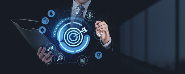 Poster - Businessman with digital target and business icons on dark backg