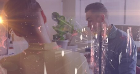 Aufkleber - At desk, two people working with fireworks animation overlaid on screen