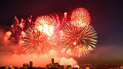 Aufkleber - Two fireworks are lit up in the sky. One is in the left side of the image and the other is in the right side