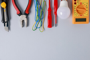 Poster - Different electrical tools on grey background, flat lay. Space for text
