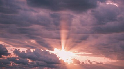 Poster - Sunset with sunbeams breaking through clouds in pink sky. Serene evening concept