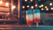 © mizan - Two ice cream sticks with red, white and blue colors. The sticks are on a wooden table