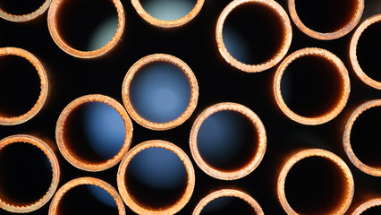 Poster - A row of pipes with a brownish color. The pipes are stacked on top of each other. industrial concept background