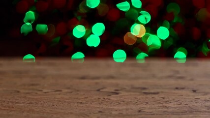 Poster - Wooden table with green and red bokeh lights, festive decoration concept