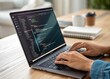 © Eyhenia - A close-up of a software developer typing on a laptop, with lines of code displayed on the screen in a dark mode interface