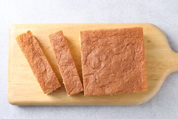 Wall Mural - Tasty Japanese Castella sponge cake on light table, top view