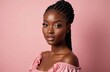 © miss irine - Portrait of attractive young dark-skinned female model in pink outfit with braids hairstyle and full makeup. Beautiful African American woman poses in studio on pink background. Beauty concept.