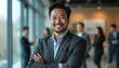 © miss irine - Portrait of handsome Asian Indian businessman in suit, stands confidently in office in front of team. Smiling corporate leader, successful entrepreneur. Modern workplace. Happy employee. Pro