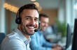 © miss irine - Close-up portrait of smiling businessman wearing headset during video call. Man looks camera at call center. Happy corporate employee provides client support, answers questions. support, customer
