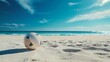 © Sarvana - A volleyball on a sandy beach with waves in the distance