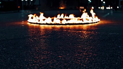 Poster - Burning circle on dark street with glowing flames, fiery spectacle at night