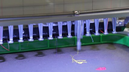 Poster - A sewing machine is in use, stitching colorful of fabric. The machine is bright and shiny, and the fabric