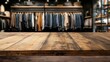 © artbot - Wooden Table in Clothing Store with Hangers Displayed