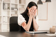 © Pixel-Shot - Sad young businesswoman with bruised arms and laptop sitting at table in office