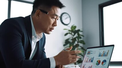 Businessman uses capable laptop computer to analyse business data analytic for marketing strategy and customer relationship management