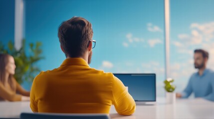 Poster - Professional man sitting at a modern desk with a laptop open and engaged in work or study
