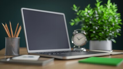 Poster - Sleek laptop placed next to a vibrant green plant on a clean desk evoking a fresh atmosphere