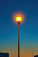 Poster - A street lamp shaped like a glowing light bulb, representing urban creativity