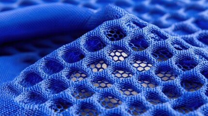 Vivid detail of blue net fabric showcasing an abstract texture with an intricate pattern and weave in macro view