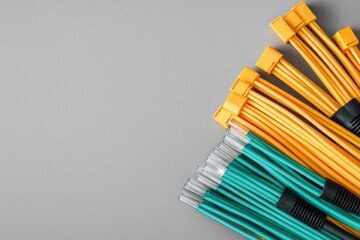 Poster - Vibrant Yellow and Green Fiber Optic Cables on Grey Background Studio Shot High Angle View Data Concept