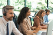 © ty - Attractive positive young businesspeople and colleagues in a call center office.