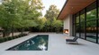 © Jaroon - A large house with a pool and a fireplace. The pool is surrounded by trees and the house has a modern design