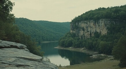 Poster - Scenic view showing a calm lake between forested hills and cliffs