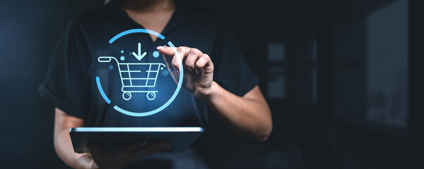 Poster - woman using a tablet with a holographic shopping cart icon, representing online shopping and e-comme