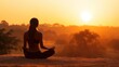 © Penatic Studio - Woman meditating in lotus position facing a beautiful sunset scene