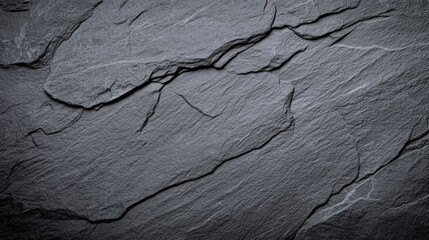 Poster - A textured surface of dark slate rock with natural lines and cracks, showcasing a rugged and earthy aesthetic.