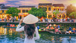 © tawatchai1990 - Asian woman wearing vietnam culture traditional at Hoi An ancient town,Hoi an city in Vietnam.