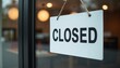 © Albina - White sign 'CLOSED' hanging at the entrance with a modern interior background