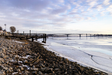 Wall Mural - stone riverbank of frozen river in Kostroma city
