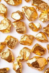 Poster - A pile of golden foil rocks arranged neatly on a white background, ideal for decorative or design purposes