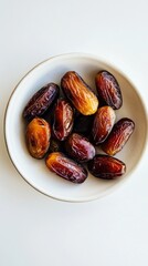 Poster - Fresh dates placed in a white bowl on a table, ready to be enjoyed