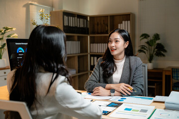 Poster - Businesswomen discussing marketing strategy using charts on desk and computer in office