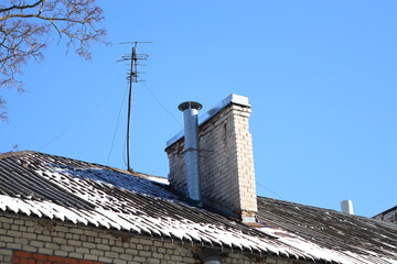 Poster - A photo of a brick building with a chimney on top, suitable for use in architectural or urban planning contexts.