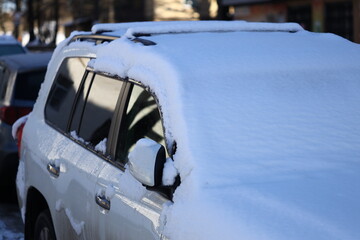 Poster - A vehicle covered in snow on a busy city street.